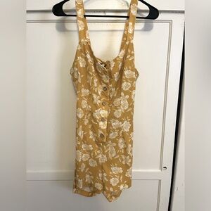 Yellow and white romper with open tie back and button front. Size M